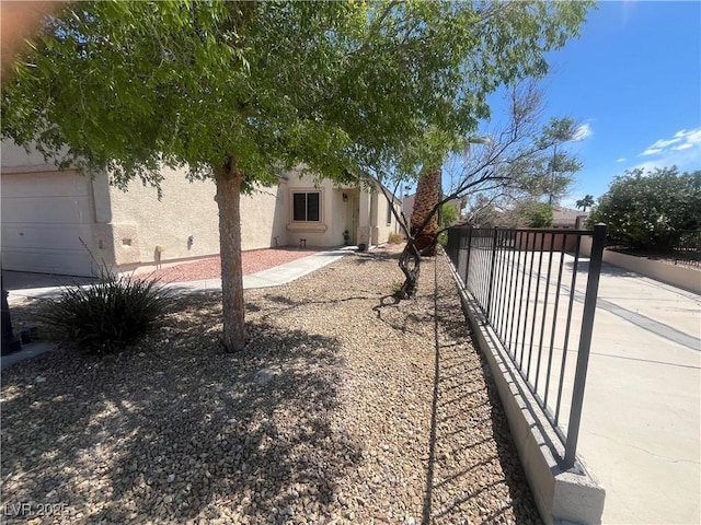 exterior space with a garage and fence