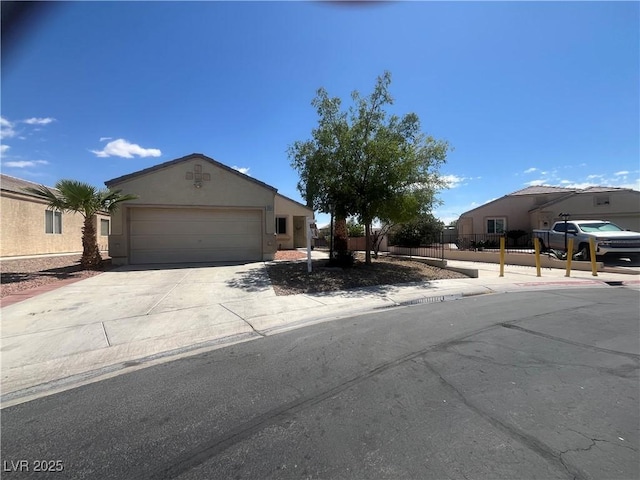 view of front of home with an attached garage, stucco siding, and driveway