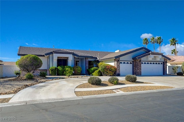 view of front of property featuring a garage and concrete driveway