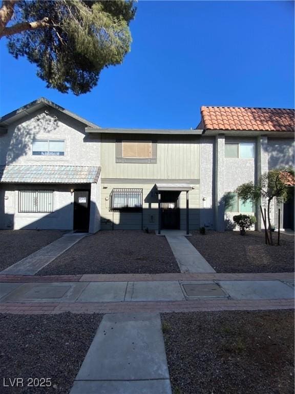 view of front of home with a tile roof