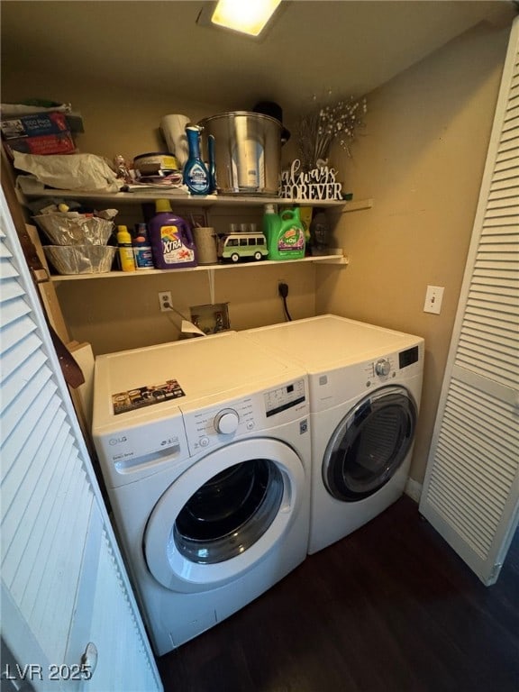 laundry area with washing machine and clothes dryer, laundry area, and wood finished floors