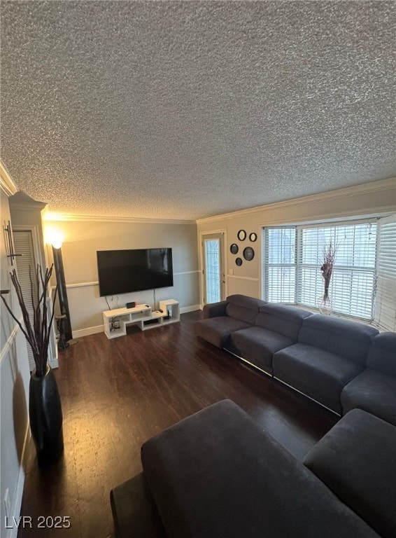 living room with baseboards, ornamental molding, a textured ceiling, and wood finished floors