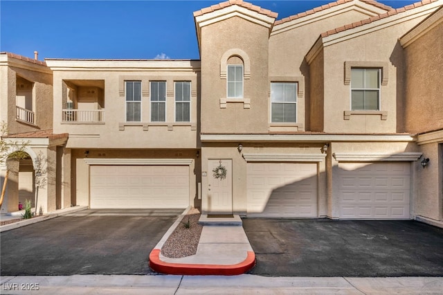 10550 W Alexander Rd Unit 2103, Las Vegas, NV 89129 - townhome / multi-family property featuring an attached garage, stucco siding, and driveway