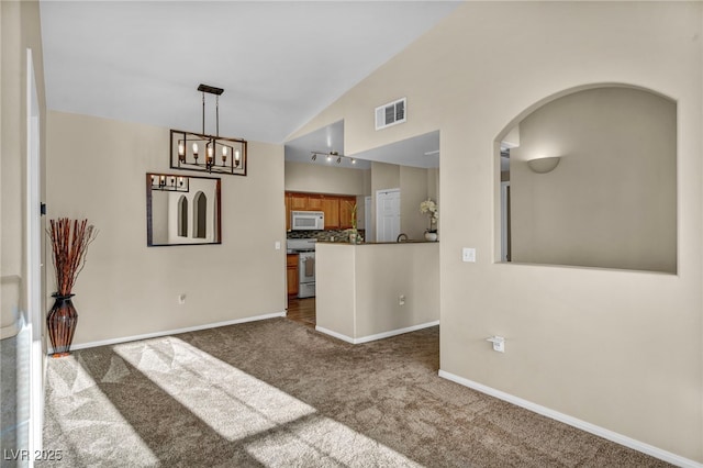 10550 W Alexander Rd Unit 2103, Las Vegas, NV 89129 - unfurnished living room with dark colored carpet, arched walkways, a chandelier, and high vaulted ceiling