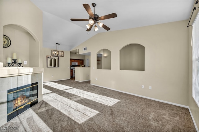 10550 W Alexander Rd Unit 2103, Las Vegas, NV 89129 - unfurnished living room featuring carpet flooring, vaulted ceiling, a fireplace, a ceiling fan, and a chandelier