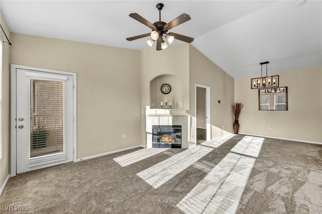 10550 W Alexander Rd Unit 2103, Las Vegas, NV 89129 - unfurnished living room featuring carpet, a tiled fireplace, a ceiling fan, lofted ceiling, and a chandelier