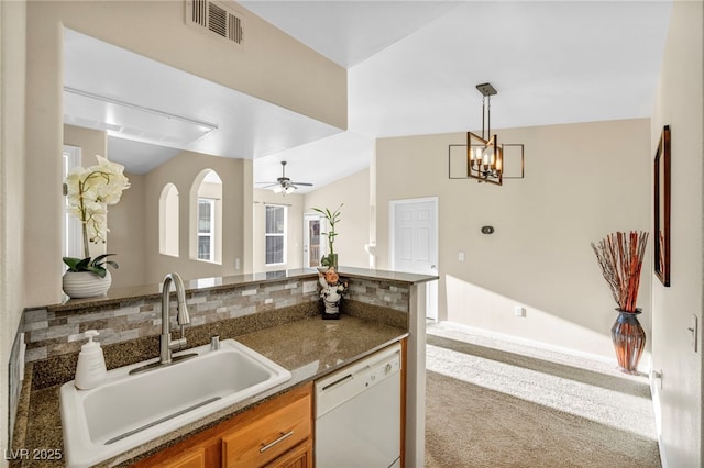 10550 W Alexander Rd Unit 2103, Las Vegas, NV 89129 - kitchen featuring dishwasher, brown cabinetry, decorative backsplash, a chandelier, and pendant lighting