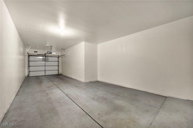 garage with a garage door opener and baseboards