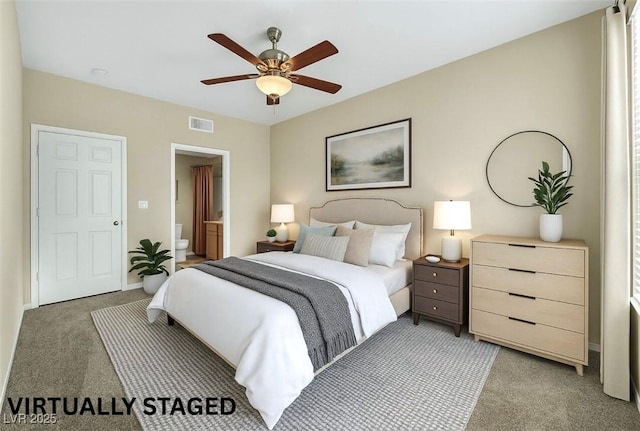 10550 W Alexander Rd Unit 2103, Las Vegas, NV 89129 - bedroom with light colored carpet, ensuite bathroom, and a ceiling fan