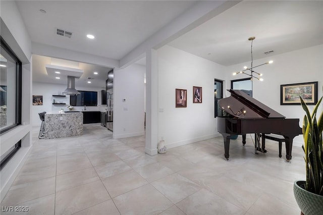 interior space featuring visible vents, baseboards, light tile patterned flooring, and a notable chandelier