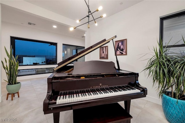 living area with a chandelier, light tile patterned flooring, baseboards, and visible vents