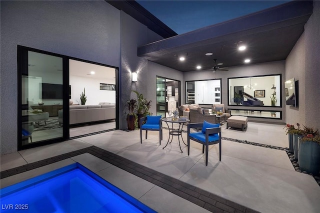 view of patio featuring an outdoor hangout area, a ceiling fan, and a swimming pool