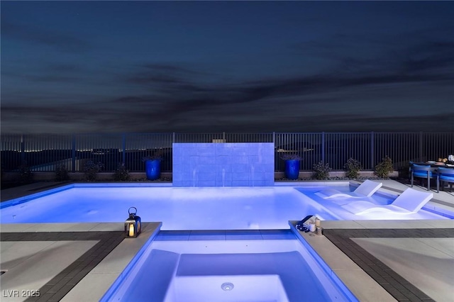 view of pool featuring an in ground hot tub, a fenced in pool, and a fenced backyard