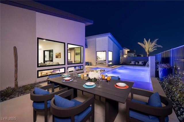 exterior space featuring outdoor dining space, a fenced in pool, and a fenced backyard