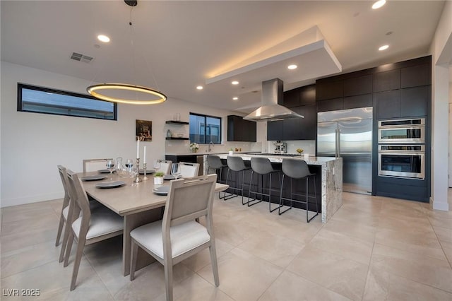 dining space with baseboards, light tile patterned floors, visible vents, and recessed lighting