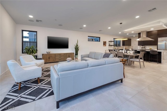 living room featuring visible vents and recessed lighting