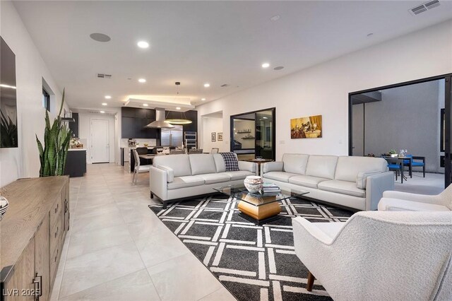 living area featuring recessed lighting and visible vents