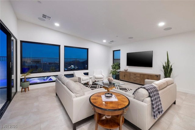 living room with light tile patterned flooring, visible vents, and recessed lighting