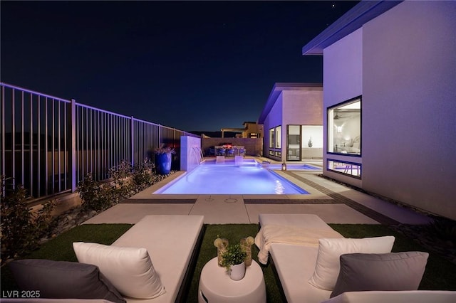 pool at twilight featuring a patio, a fenced backyard, and a fenced in pool