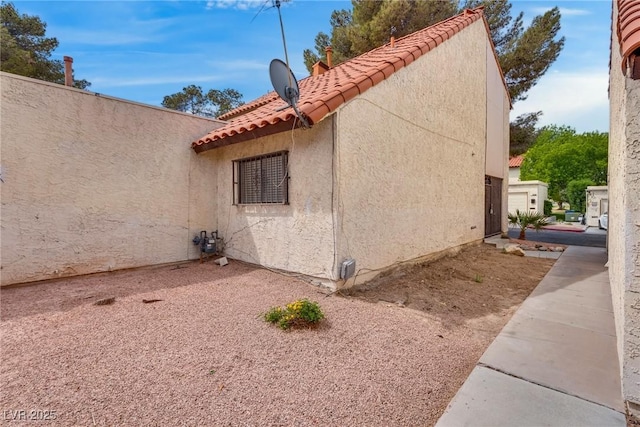 3350 Duece St, Las Vegas, NV 89121 - view of property exterior featuring a tiled roof and stucco siding