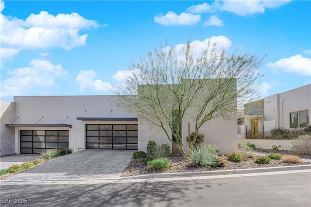 658 Falcon Summit Ct, Henderson, NV 89012 - view of front of property featuring decorative driveway, stucco siding, and a garage