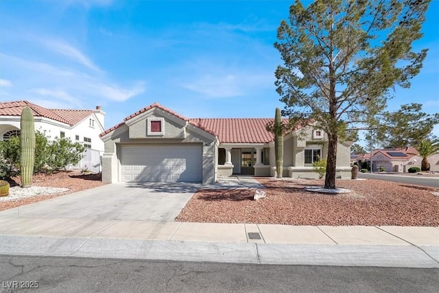 mediterranean / spanish-style house with a tile roof, concrete driveway, a garage, and stucco siding