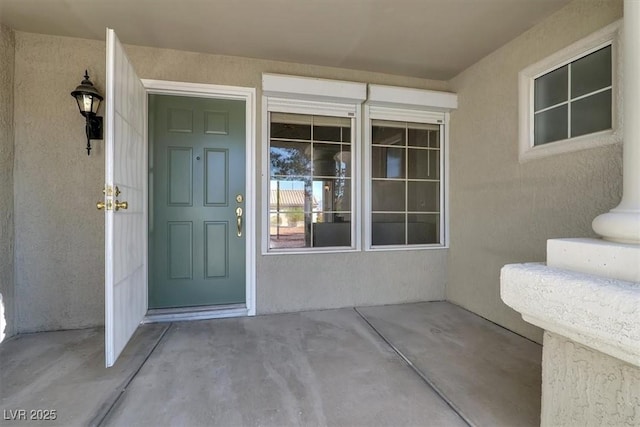 entrance to property with stucco siding