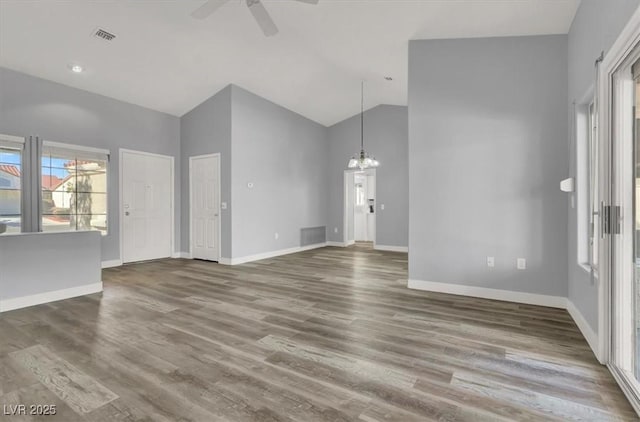 unfurnished living room featuring ceiling fan with notable chandelier, visible vents, and wood finished floors
