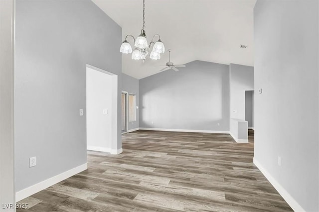 interior space with high vaulted ceiling, wood finished floors, baseboards, ceiling fan with notable chandelier, and visible vents
