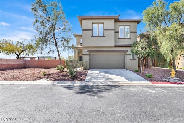 view of front facade with a garage, concrete driveway, stucco siding, and fence