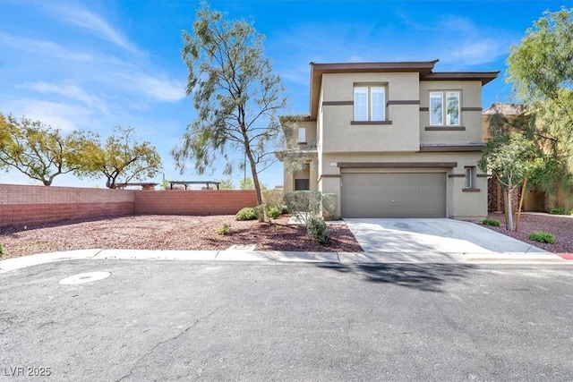 view of front of home featuring stucco siding, a garage, fence, and concrete driveway