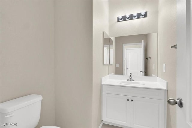 bathroom featuring toilet and vanity