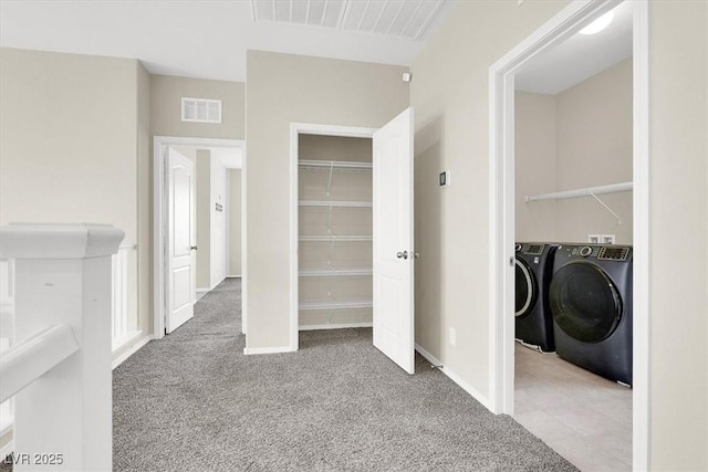 interior space featuring visible vents, washing machine and clothes dryer, laundry area, and carpet