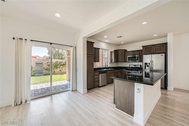 11913 Alava Ave, Las Vegas, NV 89138 - kitchen with appliances with stainless steel finishes, dark countertops, plenty of natural light, dark brown cabinets, and recessed lighting