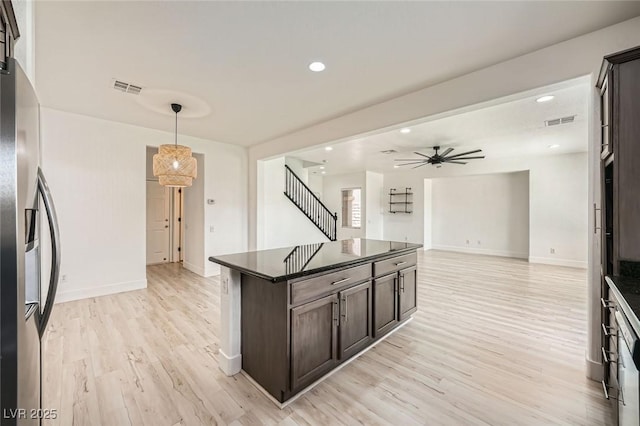 11913 Alava Ave, Las Vegas, NV 89138 - kitchen with dark countertops, dark brown cabinets, stainless steel fridge with ice dispenser, light wood finished floors, and a ceiling fan