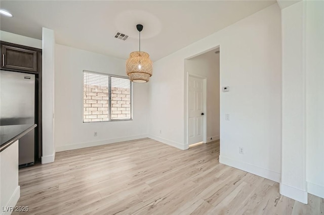 11913 Alava Ave, Las Vegas, NV 89138 - unfurnished dining area featuring light wood-type flooring and baseboards