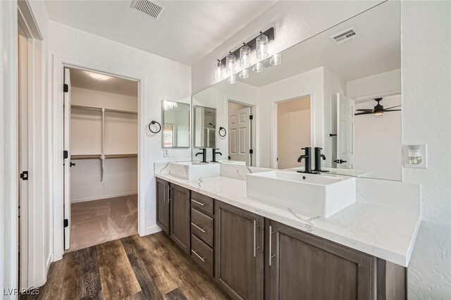 11913 Alava Ave, Las Vegas, NV 89138 - full bath featuring double vanity, wood finished floors, a ceiling fan, and a spacious closet