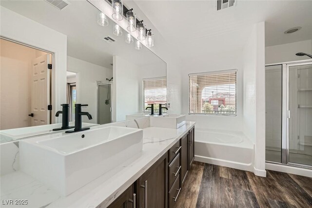 11913 Alava Ave, Las Vegas, NV 89138 - full bath with vanity, a shower stall, wood finished floors, and a garden tub