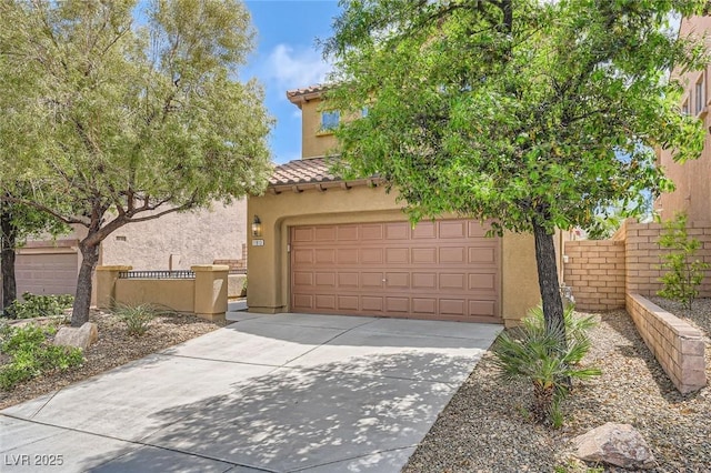 11913 Alava Ave, Las Vegas, NV 89138 - view of front of house featuring driveway, a tiled roof, stucco siding, and an attached garage