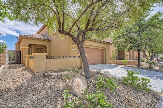 11913 Alava Ave, Las Vegas, NV 89138 - mediterranean / spanish home with concrete driveway, a tiled roof, a fenced front yard, a garage, and a gate