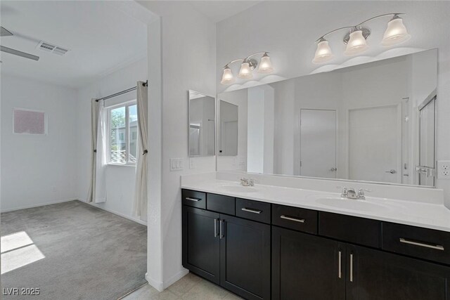 5589 Pico Ferrera Ct, Las Vegas, NV 89113 - full bath featuring a sink, double vanity, baseboards, and visible vents
