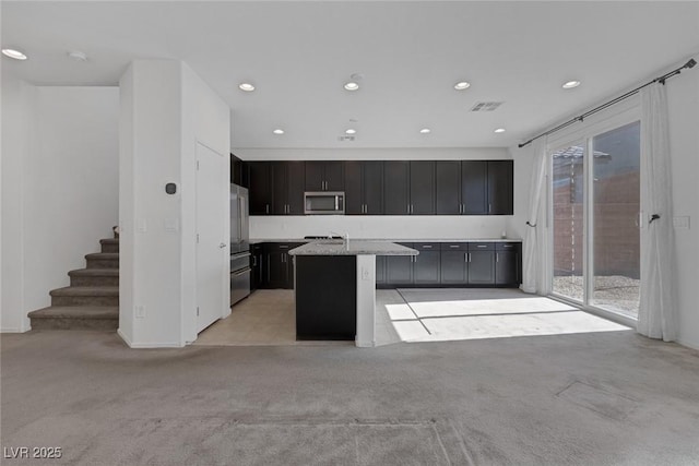 5589 Pico Ferrera Ct, Las Vegas, NV 89113 - kitchen featuring recessed lighting, a center island, visible vents, stainless steel appliances, and light colored carpet