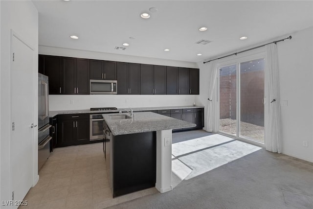 5589 Pico Ferrera Ct, Las Vegas, NV 89113 - kitchen with a sink, stainless steel appliances, visible vents, and a center island with sink