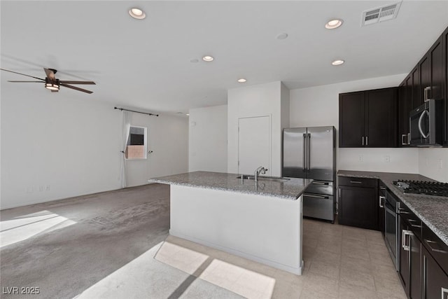 5589 Pico Ferrera Ct, Las Vegas, NV 89113 - kitchen with stone countertops, a sink, visible vents, open floor plan, and appliances with stainless steel finishes