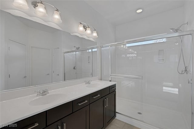 5589 Pico Ferrera Ct, Las Vegas, NV 89113 - full bathroom with a sink, double vanity, a shower stall, and tile patterned floors