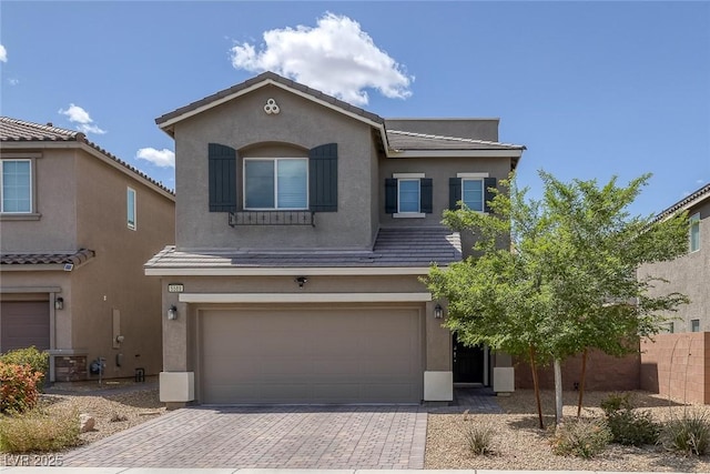 5589 Pico Ferrera Ct, Las Vegas, NV 89113 - traditional home featuring an attached garage, stucco siding, decorative driveway, and fence