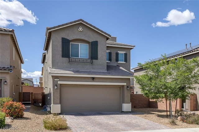 5589 Pico Ferrera Ct, Las Vegas, NV 89113 - traditional home featuring an attached garage, stucco siding, decorative driveway, and fence