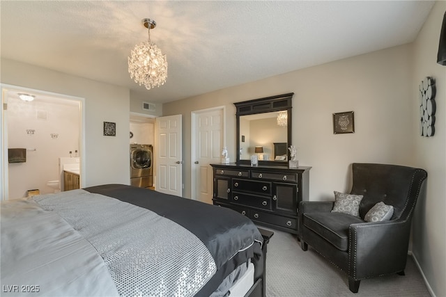 7900 Fossil Creek Ln Unit 103, Las Vegas, NV 89145 - bedroom featuring an inviting chandelier, carpet, ensuite bath, visible vents, and washer / dryer