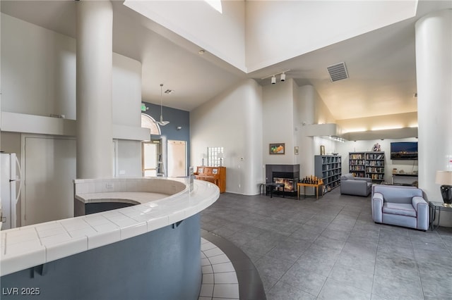 7900 Fossil Creek Ln Unit 103, Las Vegas, NV 89145 - interior space featuring high vaulted ceiling, tile patterned flooring, and visible vents
