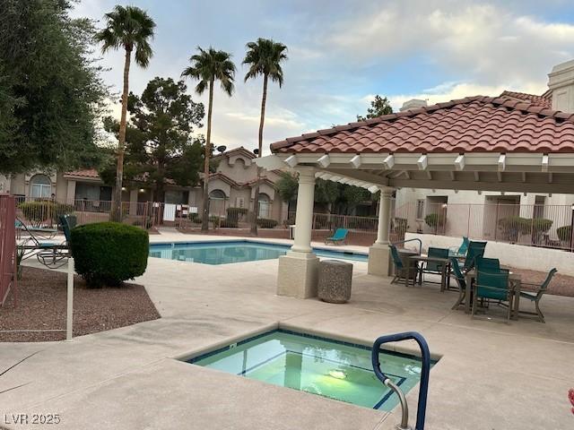 7900 Fossil Creek Ln Unit 103, Las Vegas, NV 89145 - pool featuring a patio area, a community hot tub, and fence